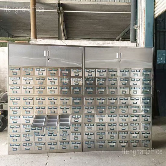 Stainless steel herb storage cabinet in a chain TCM pharmacy showing clean organized layout