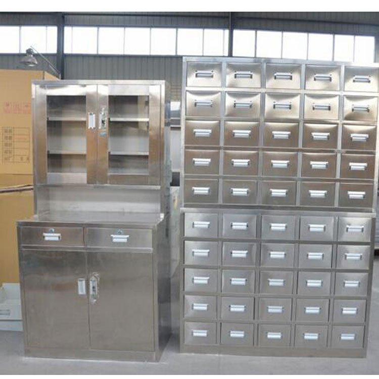Stainless steel herb cabinet installed in a small acupuncture clinic, surrounded by treatment tables and professional clinic decor.